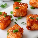 Delicious Bang Bang Salmon Bites served on a plate with dipping sauce